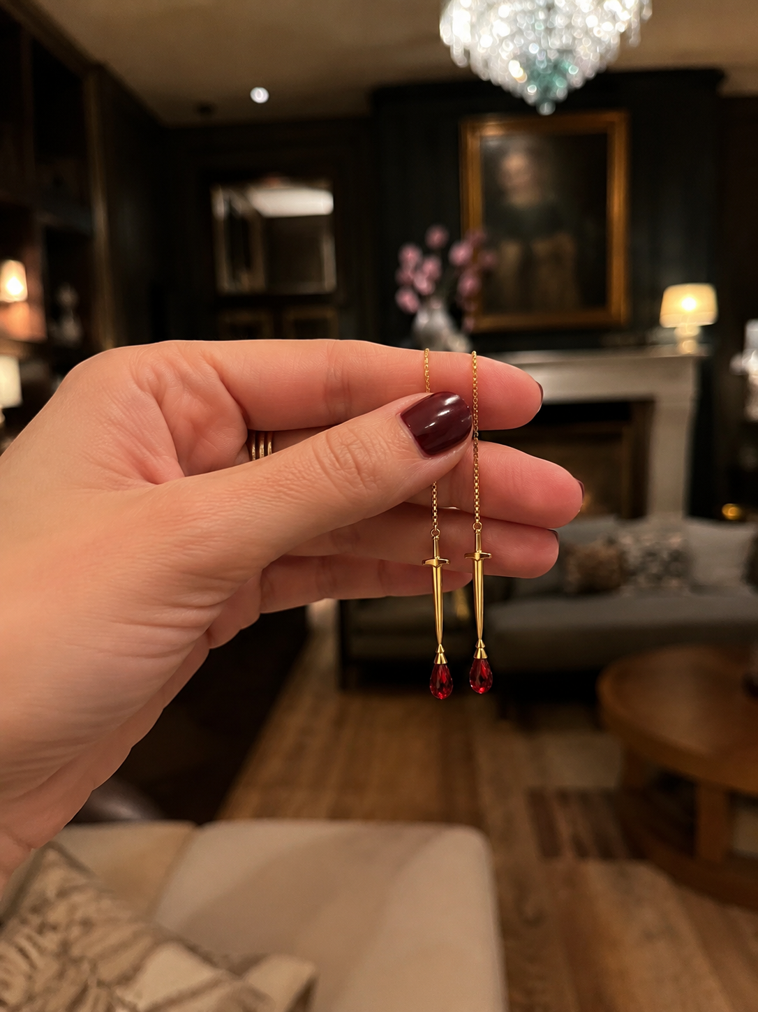 Hand holding 18K gold sword hilt threader earring - the sovereign by eliza