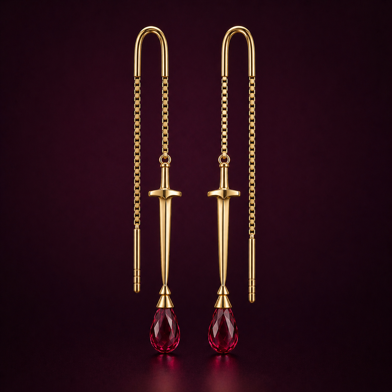 Front view of The Sovereign sword threader earrings in solid 18k gold with briolette ruby drop, from the Aurkhem collection by Eliza.