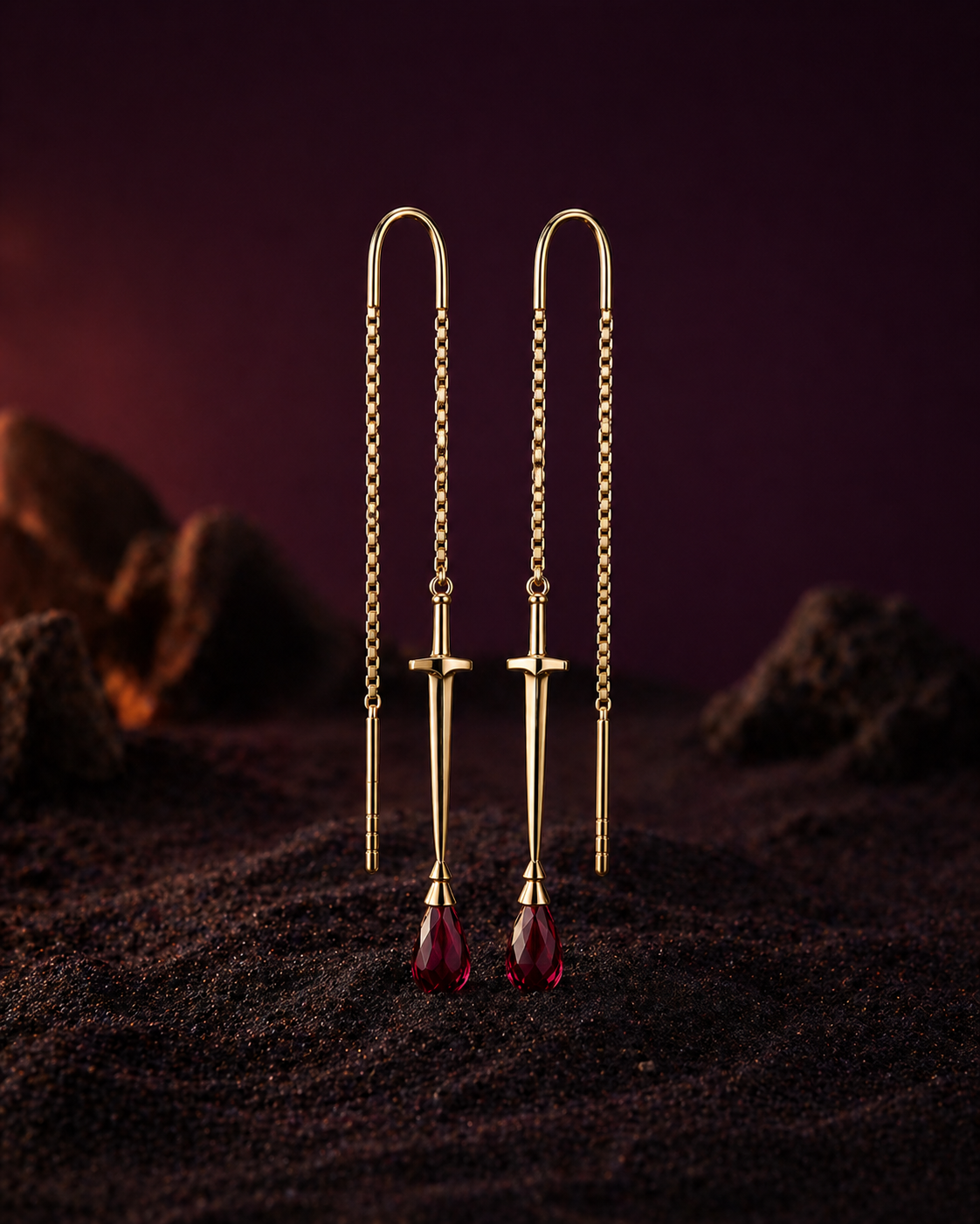 The sovereign solid 18k gold sowrd threader earrings standing onthe sand